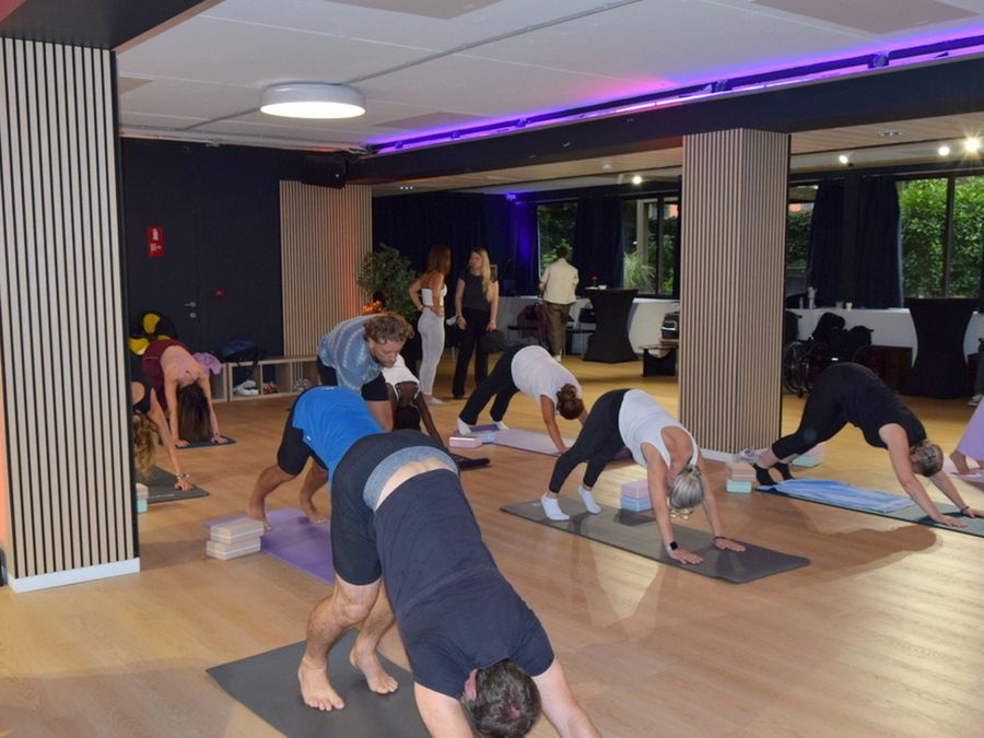 A yoga class on mats in the big room at Studio 28.